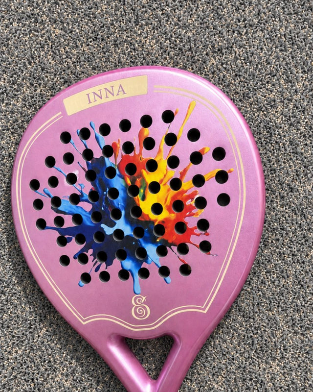 Miami Rose padel racket with custom paint-splash artwork engraved across the face and the owner's name above it