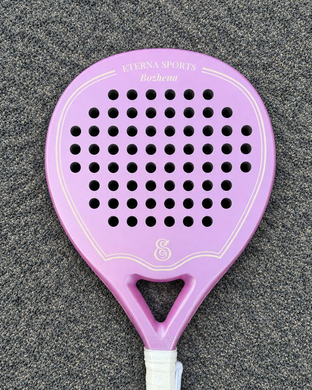 Miami Rose padel racket engraved with the owner's first name on the Crown, on a grey court