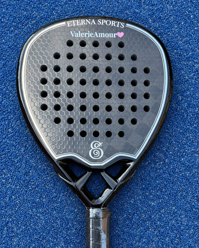 Tribeca Laser Black padel racket engraved with a name and a heart on the Crown, on a blue court