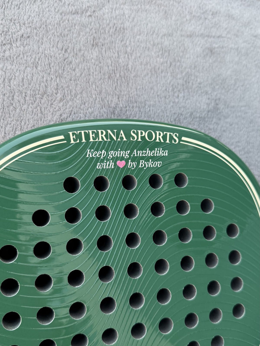 Close-up of a personal message engraved on a green Eterna Sports racket