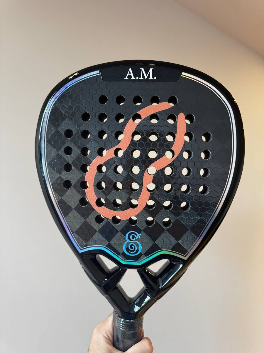 Black Eterna Sports racket with custom artwork and initials engraved, held up by its owner
