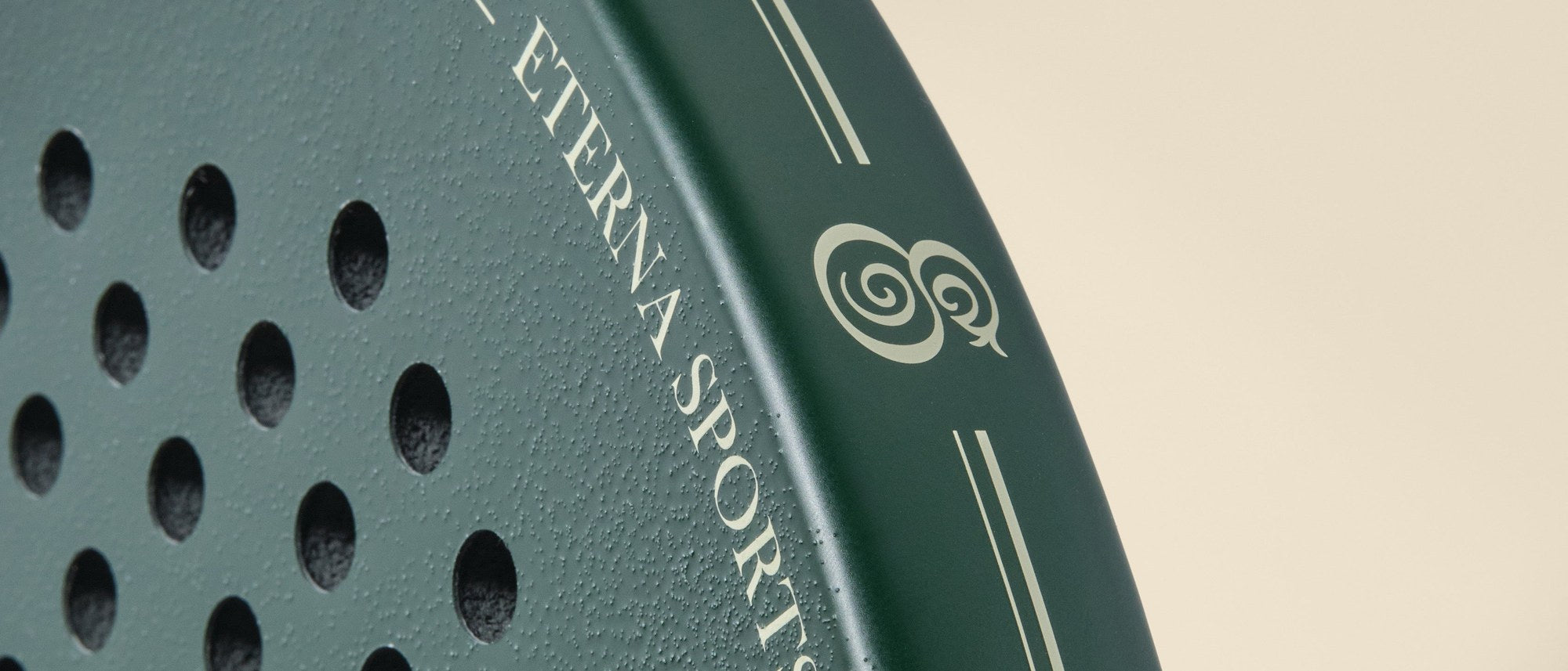 The face of the Eterna Bel Air Green padel racket in close-up, textured surface and wordmark at the crown