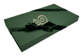 The Eterna gift box — hunter green with the monogram in cream, tied with a velvet ribbon