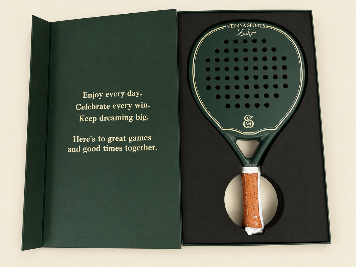 Green Eterna padel racket in an open gift box with engraving and a personal message.