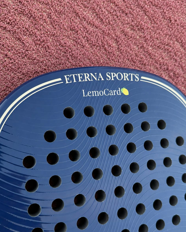 Soho Blue Glossy padel racket engraved with a brand name on the Crown, close-up