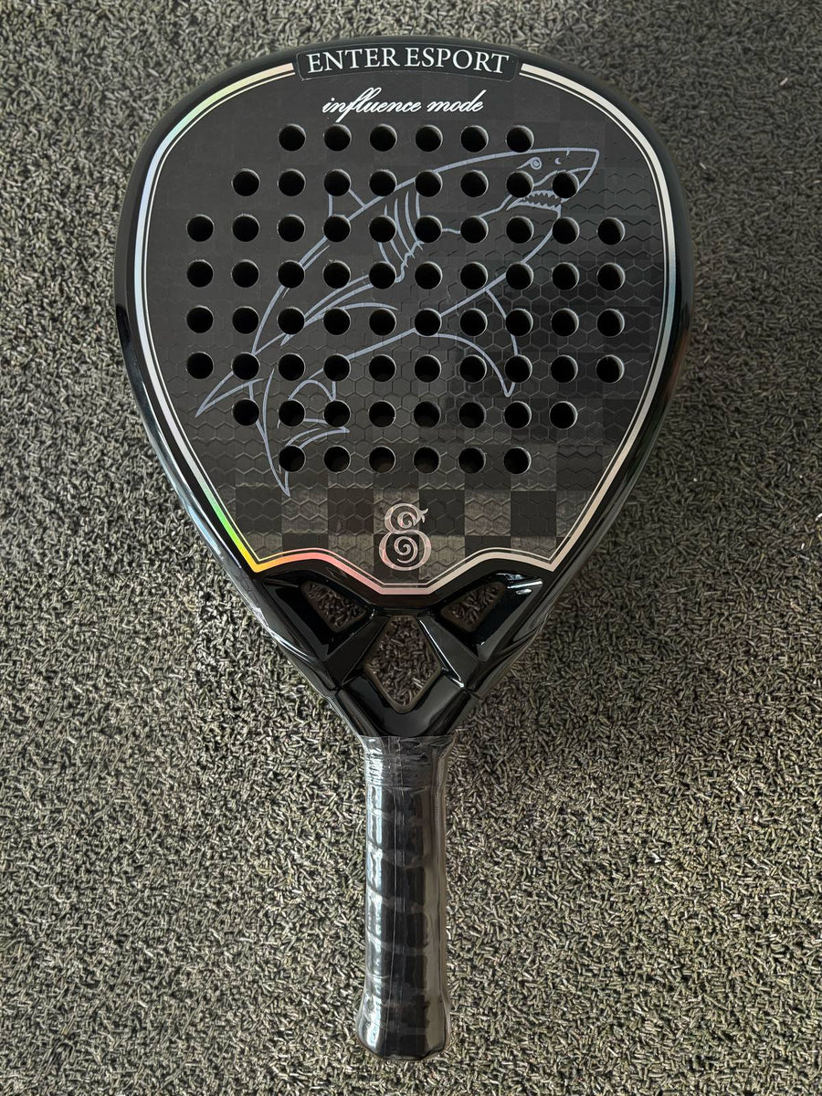 Custom shark artwork engraved across the face of an Eterna Sports racket, on the court