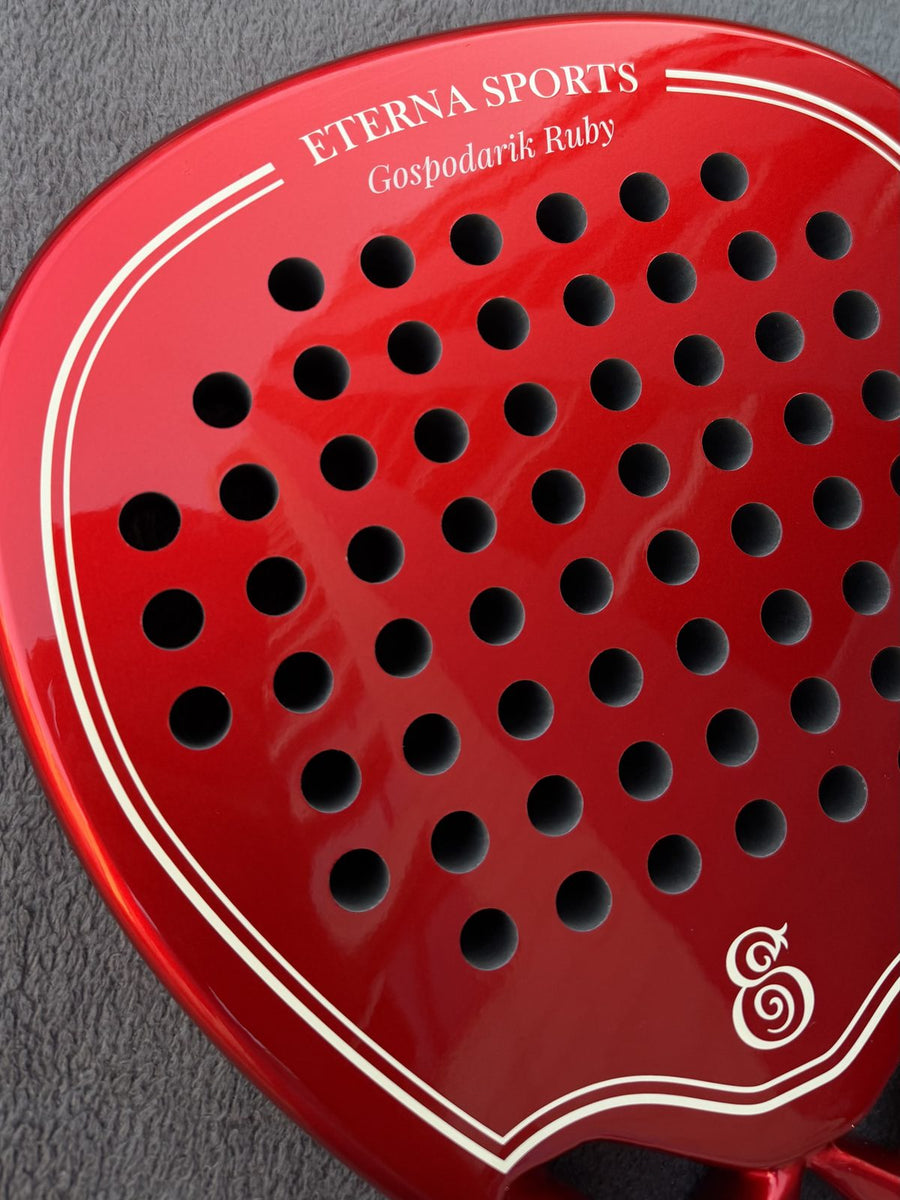 Close-up of the name engraving on a red Eterna Sports racket